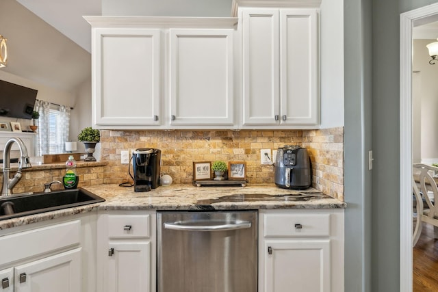 kitchen with dishwasher, white cabinets, and a sink