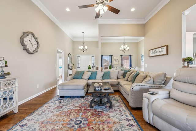 living area featuring baseboards, ceiling fan with notable chandelier, wood finished floors, and crown molding