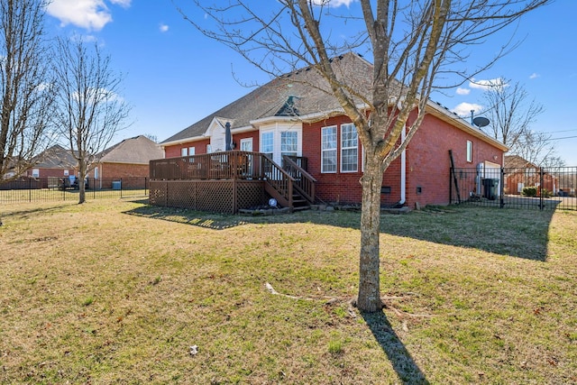 view of front facade featuring a fenced backyard, brick siding, crawl space, a wooden deck, and a front yard