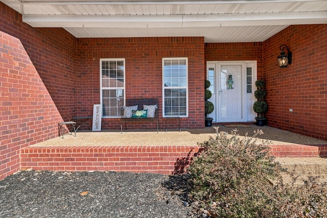 property entrance featuring brick siding