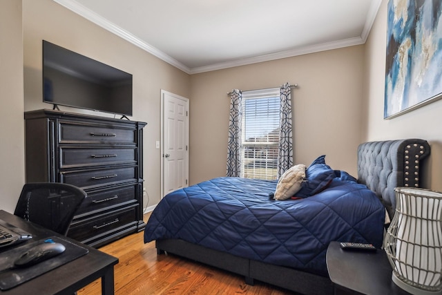 bedroom featuring crown molding and wood finished floors