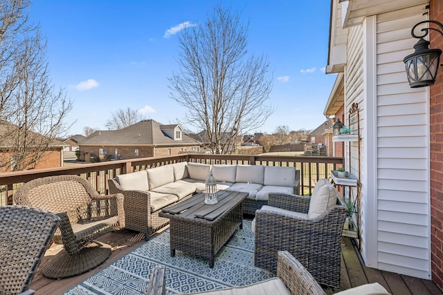 wooden terrace featuring outdoor lounge area and a residential view