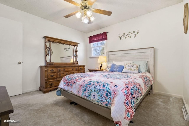 bedroom with a ceiling fan, carpet flooring, and baseboards