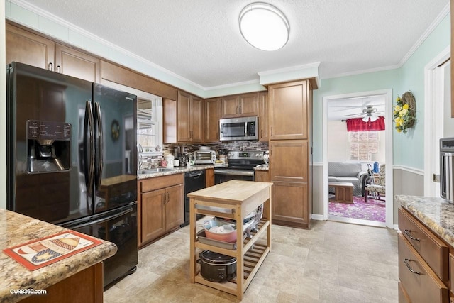 kitchen with crown molding, tasteful backsplash, brown cabinetry, a textured ceiling, and black appliances