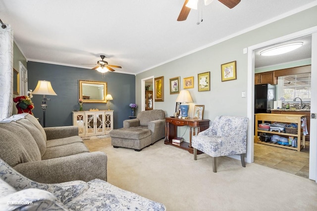 living room with light carpet, ornamental molding, and a ceiling fan