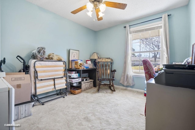 office area featuring ceiling fan, a textured ceiling, carpet flooring, and baseboards