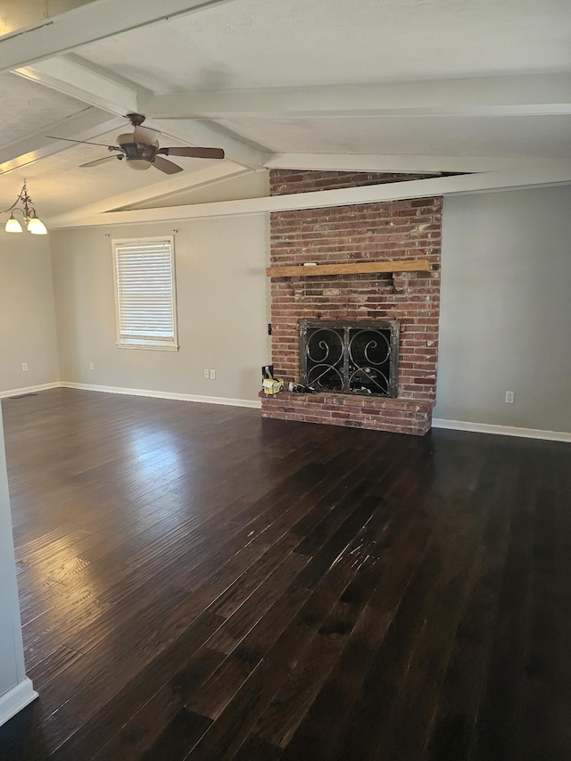 unfurnished living room with a brick fireplace, lofted ceiling with beams, baseboards, and wood finished floors