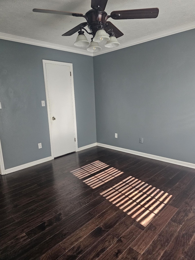 empty room with baseboards, a textured ceiling, wood finished floors, and crown molding