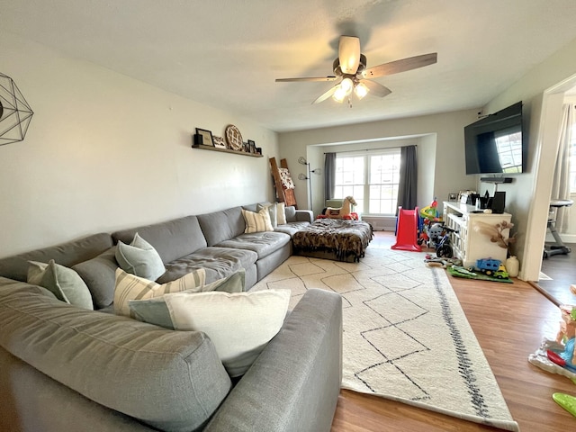 living room featuring ceiling fan and wood finished floors