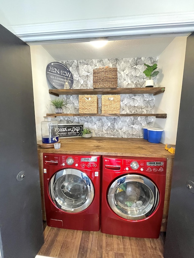 laundry room featuring laundry area, washer and clothes dryer, and wood finished floors