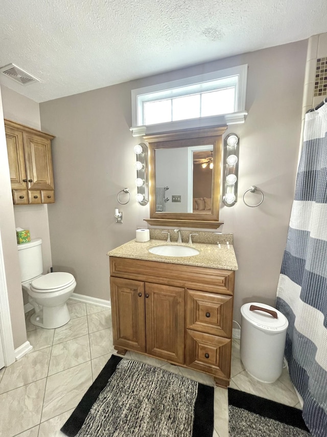 full bath with visible vents, vanity, toilet, and a textured ceiling