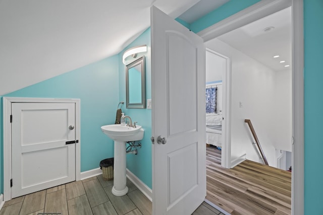 bathroom with recessed lighting, baseboards, and wood finish floors