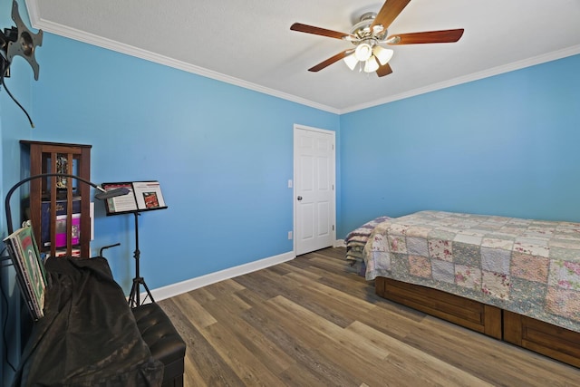 bedroom with ornamental molding, a ceiling fan, baseboards, and wood finished floors