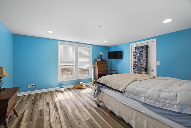 bedroom featuring recessed lighting, baseboards, and wood finished floors