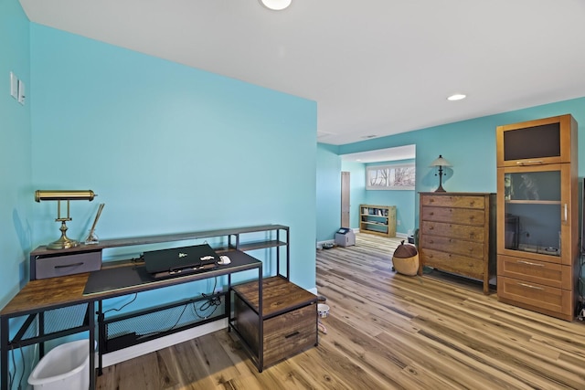 home office featuring wood finished floors and recessed lighting