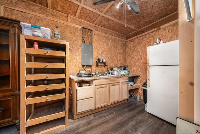 kitchen featuring electric panel, a ceiling fan, dark wood-style flooring, freestanding refrigerator, and light countertops