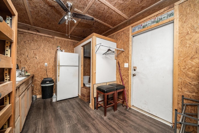 interior space with ceiling fan, open shelves, dark wood-type flooring, and freestanding refrigerator