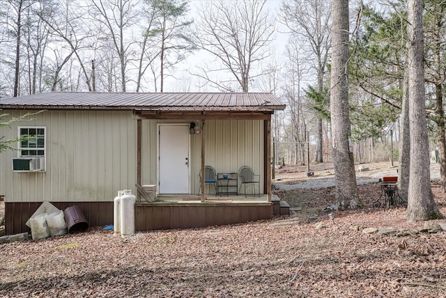 exterior space featuring cooling unit and metal roof