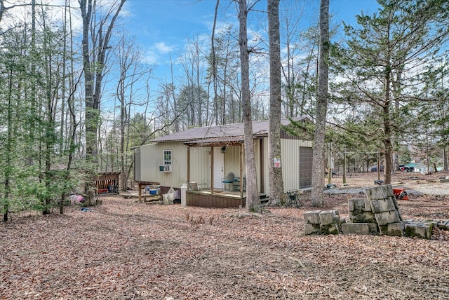 rear view of house featuring metal roof