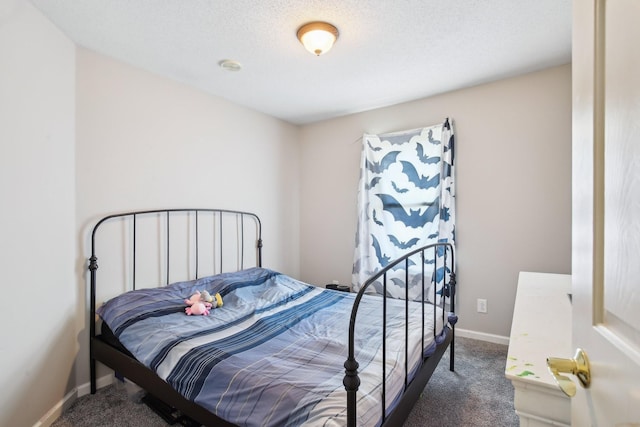 bedroom featuring carpet flooring, a textured ceiling, and baseboards