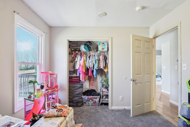 bedroom featuring a closet, carpet flooring, and baseboards