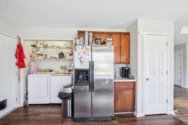 kitchen featuring brown cabinetry, stainless steel fridge with ice dispenser, dark wood-style flooring, light countertops, and washer and dryer