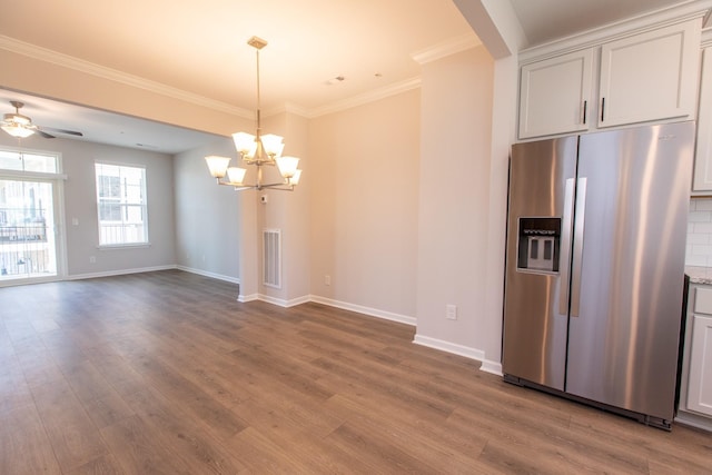 kitchen with visible vents, crown molding, stainless steel fridge with ice dispenser, and wood finished floors