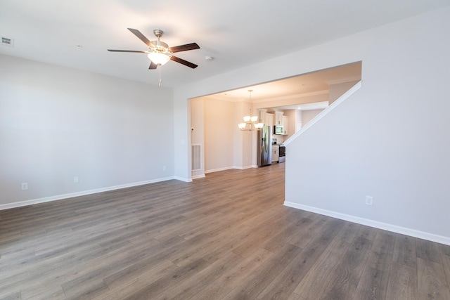 unfurnished living room with visible vents, baseboards, dark wood-style flooring, and ceiling fan with notable chandelier