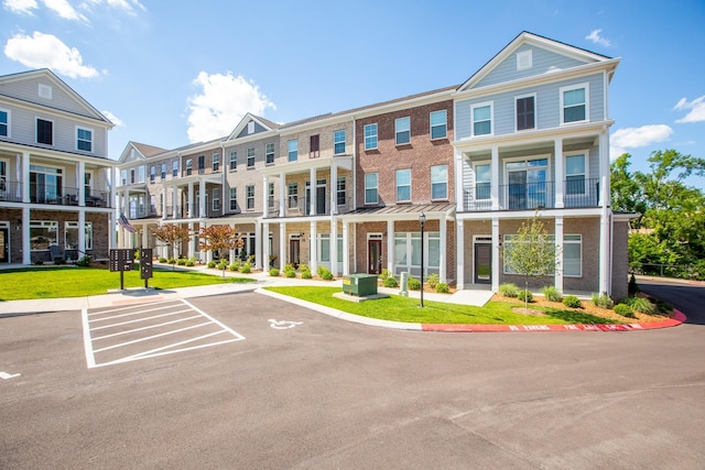 view of property with uncovered parking, a residential view, and central AC