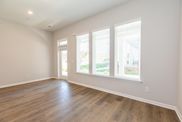 empty room featuring baseboards and wood finished floors