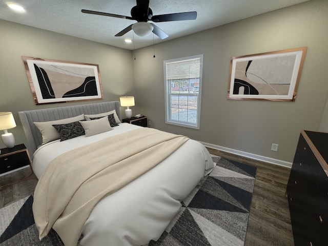 bedroom featuring baseboards, a ceiling fan, wood finished floors, a textured ceiling, and recessed lighting