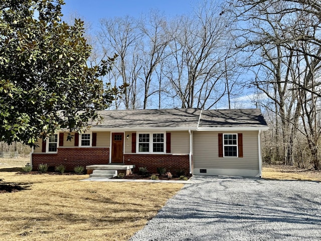 single story home featuring driveway and brick siding