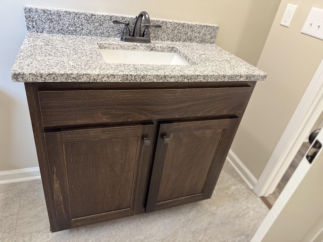 bathroom with vanity and baseboards