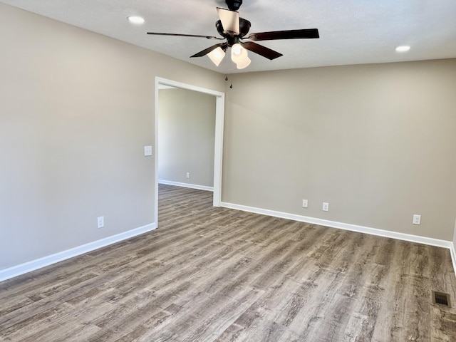 spare room featuring visible vents, baseboards, ceiling fan, wood finished floors, and recessed lighting