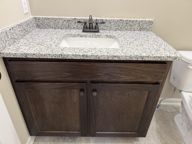 bathroom featuring toilet and vanity