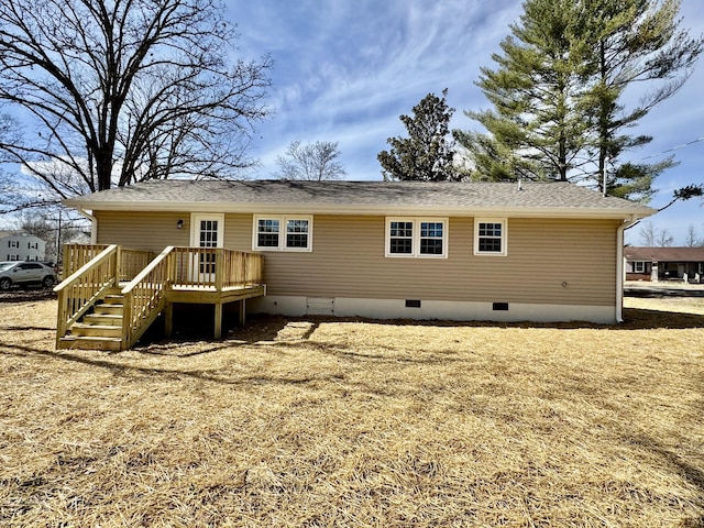 rear view of property featuring a deck and crawl space