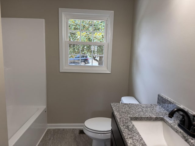 bathroom with baseboards, vanity, and toilet