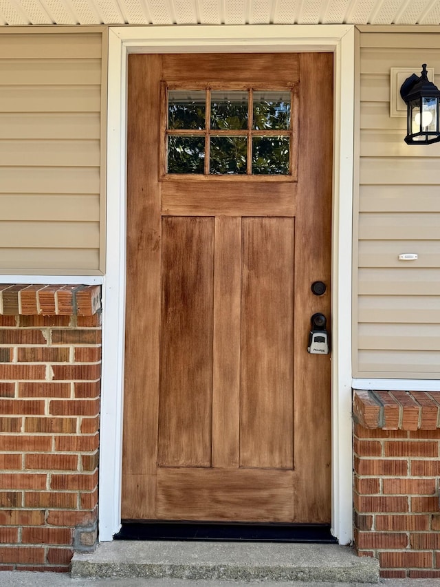 property entrance featuring brick siding