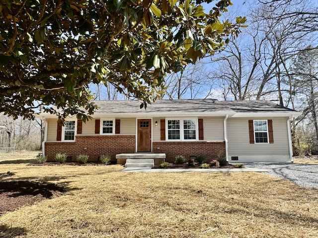 single story home with crawl space, gravel driveway, and brick siding