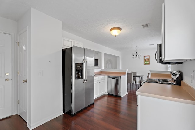 kitchen featuring stainless steel appliances, visible vents, white cabinets, light countertops, and dark wood-style floors