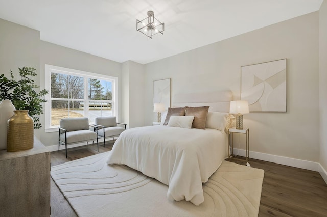 bedroom with baseboards and wood finished floors