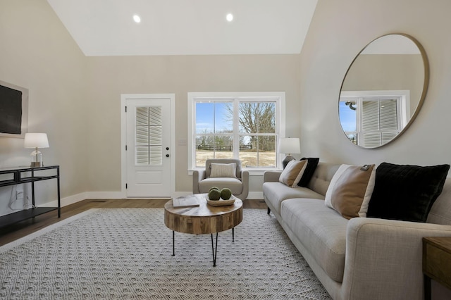 living area featuring lofted ceiling, recessed lighting, wood finished floors, and baseboards