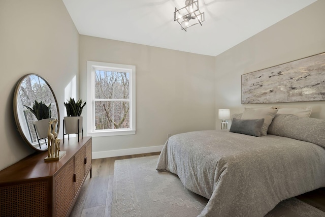 bedroom featuring wood finished floors and baseboards