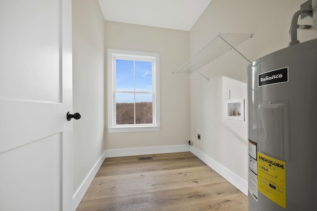 laundry area with light wood finished floors, hookup for a washing machine, electric water heater, electric dryer hookup, and laundry area