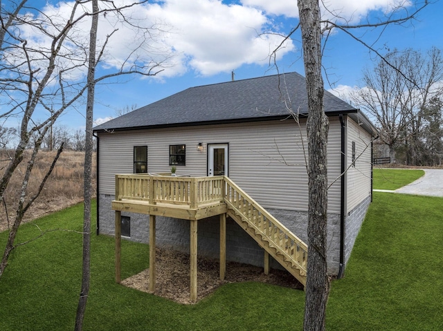 back of property featuring stairs, a deck, a lawn, and roof with shingles