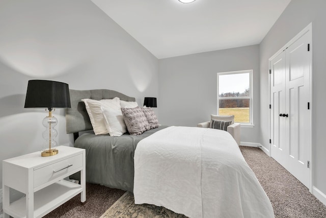 bedroom featuring lofted ceiling, carpet, and baseboards