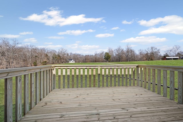 wooden terrace featuring a lawn