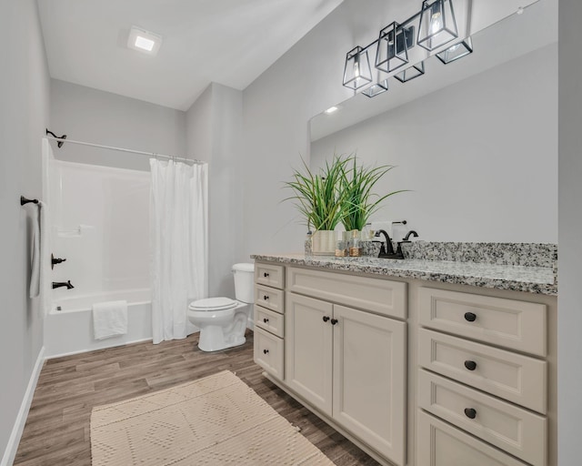 bathroom with toilet, shower / bath combo with shower curtain, vanity, wood finished floors, and baseboards