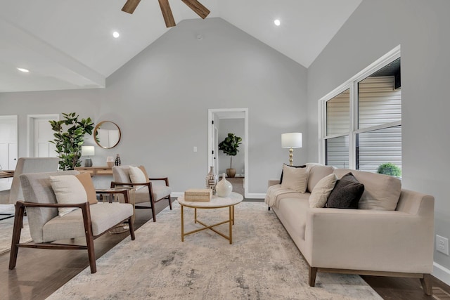 living room featuring high vaulted ceiling, recessed lighting, wood finished floors, and baseboards