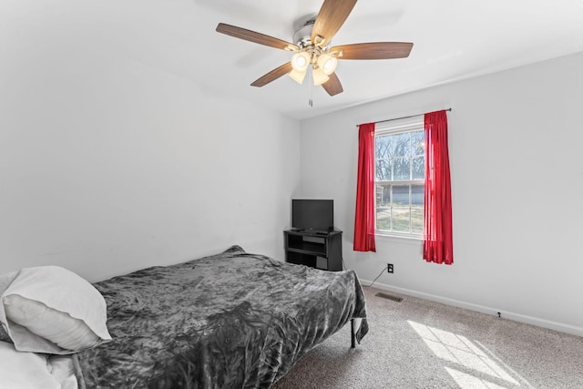 bedroom featuring ceiling fan, carpet flooring, visible vents, and baseboards